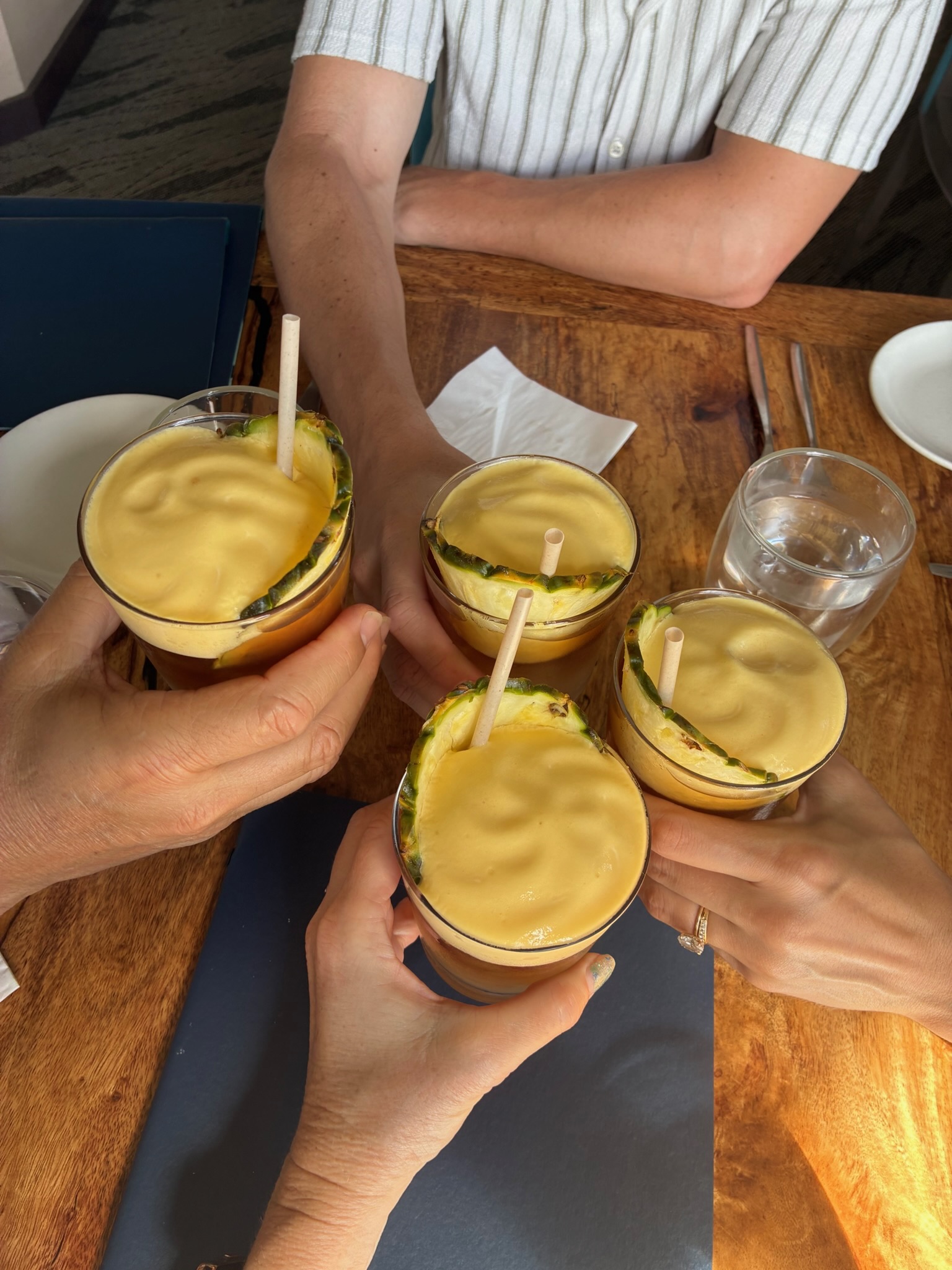 Three mai tais raised in a cheers
